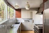 The kitchen features cork flooring and an Alvar Aalto Beehive pendant lamp.