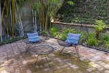 Outdoor, Small Patio, Porch, Deck, Grass, Pavers Patio, Porch, Deck, and Back Yard A bamboo grove provides privacy to the brick-paved patio in the backyard.

  Photo 12 of 15 in Calling All Richard Neutra Fans—His Bonnet House in L.A. Hits the Market at $1.8M