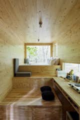 Living, Medium Hardwood, Ceiling, and Bench The cabins—all designed in-house—sport a minimalist aesthetic, deliberately pared-down to let nature take the spotlight. 

  Living Bench Medium Hardwood Ceiling Photos from Rediscover the Pleasure of Solitude in These Micro Cabins Across the East Coast