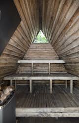 A small triangular window punctuates the interior of the floating sauna. 