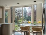 Dining Room, Table, Terrazzo Floor, Stools, and Recessed Lighting A breakfast nook in the kitchen faces a serene garden.

  Photo 8 of 15 in Own This Iconic Midcentury by Charles Haertling For $5.75M