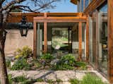Outdoor, Back Yard, Hardscapes, Hanging Lighting, Gardens, Grass, Shrubs, Trees, Garden, and Flowers A look at the rear patio gardens.  Photos from Own This Iconic Midcentury by Charles Haertling For $5.75M