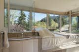 The master bathroom offers unobstructed views of the Flatirons.