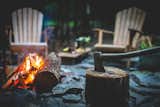 Adirondack chairs set the scene at the outdoor campfire site. Fatwood firestarter is also provided with your stay.