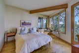 Bedroom, Bed, Medium Hardwood Floor, Table Lighting, Night Stands, and Bench A built-in window seat in the corner of the master bedroom overlooks views in two directions.

  Photo 6 of 11 in A Tetrahedron Cabin With Stellar Seaside Views Is Listed For $695K