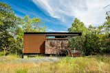 Each cabin was assembled from single, mostly completed modules craned into place and raised atop concrete piers. The cabins include a bedroom and bathroom, a study desk, a&nbsp; covered porch and a fire pit.