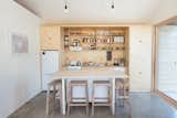 The living area and bedroom light fixtures, as well as the cabinet pulls, were sourced from Schoolhouse Electric.