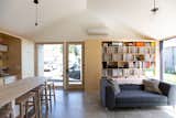 Living, Concrete, Bookcase, Sofa, Storage, Pendant, and Stools A highly efficient ductless mini-split system provides heating and cooling.  Living Storage Pendant Concrete Stools Photos from Budget Breakdown: A Portland Couple Design and Build a Compact Home for $222K