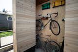 The custom storage solutions  can hold a variety of items including bicycles and bicycle trailers, house and gardening tools, camping equipment and the outdoor grill. 