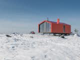 Exterior, Metal, Metal, Prefab, Cabin, Gable, and Small Home The prefab cabin is elevated atop six metal pillars to minimize site impact.   Exterior Prefab Gable Small Home Photos from Go Off-Grid in Russia With This Bright Red Prefab Cabin