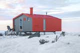 Exterior, Metal, Cabin, Prefab, Metal, Gable, and Small Home The north-end of the cabin features an outdoor deck.

  Exterior Prefab Gable Small Home Metal Photos from Go Off-Grid in Russia With This Bright Red Prefab Cabin