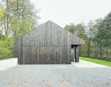 Exterior, Wood Siding Material, Gable RoofLine, and House Building Type The home is accessed from the west, where the garage is hidden behind a charred timber door.

  Photos from This Minimalist Bungalow Will Change Color Over Time