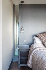 A Buster and Punch pendant light hangs in the bedroom.