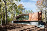 The steel-framed glazed living pavilion is partly clad in wood and sits atop CMU walls. 