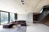 The concrete bearing walls are left exposed in the interior to tie the living spaces with the rock outcroppings.