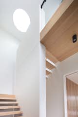 "As soon as you walk in the front door, your eye is drawn to the circular skylight above, which casts directed light to the open stairs below," explains Modscape.
