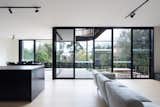 A giant wall of glass connects the living spaces with the outdoors. The double-glazed, low-e windows are thermally broken with black-powder coated frames.