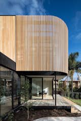 Outdoor, Small Patio, Porch, Deck, Back Yard, Walkways, and Trees The curved battened screen provides privacy for the master suite and gives the extension sculptural appeal.

  Photo 9 of 20 in 20 Impressive Australian Homes That Bring the Outdoors In from A Melbourne Home Gains a Marvelous Modular Addition