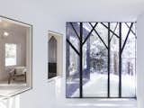 The tree-shaped window frames bring an abstract forest indoors.