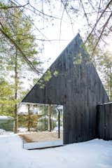 Outdoor, Trees, Wood Patio, Porch, Deck, Woodland, and Small Patio, Porch, Deck The outdoor terrace is oriented to face the lake.   Photos from This Mirrored Cabin Playfully Brings a Forest Indoors