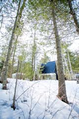 Nestled in a forest near the Kawartha Lakes in Ontario, Canada, the two-story Lake Cottage by Toronto firm UUfie is partially sheathed in one-way mirror glass. The architects clad the 23-foot-tall roof in black steel and wrapped the exterior in charred cedar siding made using the shou sugi ban technique.&nbsp;