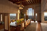Dining Room, Table, Pendant Lighting, Medium Hardwood Floor, Chair, and Rug Floor Ample glazing sweeps the cinematic landscape into the dining room, the largest space in the house.  Photo 13 of 23 in Frank Lloyd Wright’s Iconic Ennis House Is Listed For $23M