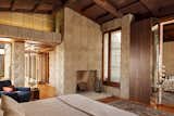 Bedroom, Bed, Medium Hardwood Floor, Chair, and Rug Floor The 6,200-square-foot property includes three bedrooms and three-and-a-half baths.  Photo 17 of 23 in Frank Lloyd Wright’s Iconic Ennis House Is Listed For $23M