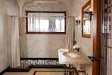Bath Room, Soaking Tub, Undermount Sink, Ceramic Tile Floor, Wall Lighting, Wall Mount Sink, and Full Shower A look inside one of the other bathrooms.   Photo 20 of 23 in Frank Lloyd Wright’s Iconic Ennis House Is Listed For $23M