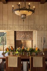 Dining Room, Chair, Medium Hardwood Floor, Table, Pendant Lighting, and Rug Floor Concrete blocks were also used to frame the interiors.   Photo 15 of 23 in Frank Lloyd Wright’s Iconic Ennis House Is Listed For $23M