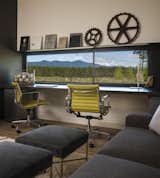 A low horizontal window is perfectly positioned in the office to frame views of the Cascade mountain range.
