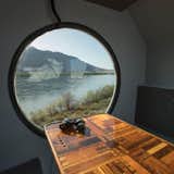 Dining Room, Table, and Bench The acrylic porthole in the breakfast nook overlooks the Columbia River.  Photo 8 of 17 in A Lunar Lander-Inspired Tiny House is an Otherworldly Escape