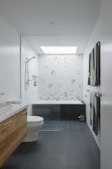 A strategically placed skylight bathes the shower area in natural light.