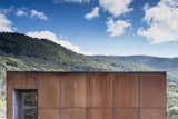 Exterior, House Building Type, Metal Roof Material, Metal Siding Material, and Flat RoofLine Bespoke Cor-Ten cladding wraps around the home to meet local bushfire regulations.  Photos from A Fire-Resistant House Cuts a Striking Figure in the Australian Bush