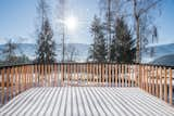 The original balcony was replaced with a larger deck built from larch. The deck is supported by diagonal steel beams that are attached to the existing concrete pillars.