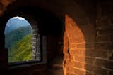 Arched windows frame views of the forested mountains of Yangqing.