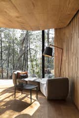 Living Room, Coffee Tables, Sofa, Light Hardwood Floor, and Floor Lighting The landscape-inspired interior features a simple color palette of grays, oranges, and blues.  Photo 5 of 13 in Escape to the Wilds of Tasmania in These Eco-Minded Pavilions