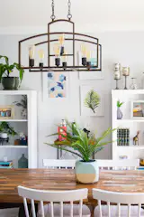The dining table and chairs were swapped out for more contemporary furnishings. To keep costs low, Janelle shopped at big box stores; the light fixture is from Costco and the chairs are from Target.