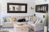 In addition to contemporary furnishings, the updated living room includes newly painted ceilings (swish coffee) along with new baseboards and crown moulding. The couple's black lab, Lola, can be seen on the sectional, which was purchased from Living Spaces.