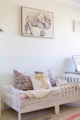 Kids, Rug, Bedroom, Toddler, Carpet, Bed, and Neutral Sienna's room has a clear elephant motif throughout.  Kids Neutral Bed Bedroom Carpet Photos from Budget Breakdown: A SoCal Couple Revamp Their Fixer-Upper For $63K