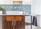 Bath, Stone, Two Piece, Vessel, and Ceramic Tile An art deco drinks trolley was repurposed as a bathroom vanity. All fixtures are low-flow.   Bath Ceramic Tile Vessel Two Piece Photos from A Cramped Bungalow Is Reborn as an Eco-Minded Home for Two Gardeners