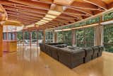 Living Room, Medium Hardwood Floor, Bar, Recessed Lighting, Sofa, Stools, and Coffee Tables Full-height glazing wraps around the home for spectacular views of the woods.   Photos from Jackie Gleason’s Spaceship-Like Mansion Hits the Market For $12M