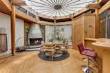 Living, Chair, Medium Hardwood, Table, Wood Burning, Corner, Stools, and Bar The home features three lavish fireplaces—each built of Carrara marble—weighing a total of 240 tons. 

  Living Bar Table Medium Hardwood Photos from Jackie Gleason’s Spaceship-Like Mansion Hits the Market For $12M