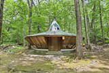 Nicknamed "The Spaceship," the small UFO-inspired cottage includes a tiny utility kitchen, bathroom, and storage. 