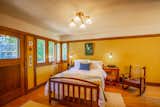 Bedroom, Bed, Chair, Ceiling Lighting, Night Stands, Table Lighting, Medium Hardwood Floor, and Rug Floor The master bedroom includes a spacious walk-in closet, as well as plenty of natural light.

  Photo 11 of 15 in Snatch Up This Rare Frank Lloyd Wright-Designed ASB Home For $777K