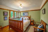 Bedroom, Medium Hardwood Floor, Ceiling Lighting, Night Stands, Bench, Bed, and Rug Floor A look inside the third bedroom, approximately 117 square feet in size.   Photo 10 of 15 in Snatch Up This Rare Frank Lloyd Wright-Designed ASB Home For $777K