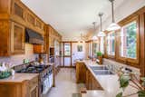 Kitchen, Pendant Lighting, Refrigerator, Drop In Sink, Range Hood, Wood Cabinet, and Range The spacious kitchen, which is located in the 1924 addition, features a Sub-Zero refrigerator and a Viking stove.

  Photo 7 of 15 in Snatch Up This Rare Frank Lloyd Wright-Designed ASB Home For $777K