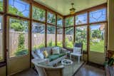 Living Room, Sofa, Coffee Tables, Chair, Ceiling Lighting, Rug Floor, and End Tables This glazed porch was a 1924 "non-Wright" addition that overlooks the backyard.

  Photo 8 of 15 in Snatch Up This Rare Frank Lloyd Wright-Designed ASB Home For $777K