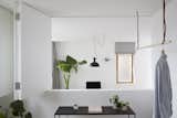 Office and Study Room Type Plants—sourced from Conservatory Archives—breathe life into the minimalist spaces. The lighting fixtures are from Blom & Blom.

  Photo 11 of 72 in Tiny Homes by Michael Tagle from A Claustrophobic London Mews House Gets a Smart Redesign