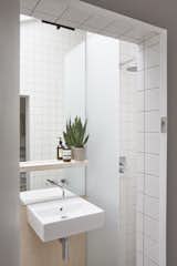 Bath Room, Enclosed Shower, Porcelain Tile Floor, Wall Mount Sink, and Porcelain Tile Wall A peek inside the bathroom. This space is lined with matte white tiles and pale gray grout.

  Photo 1 of 116 in MX ideas by See Spot Run from A Claustrophobic London Mews House Gets a Smart Redesign