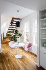 An informal eating space sits beneath the stair and next to the kitchen.